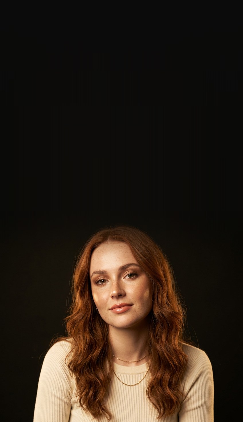 A creator in a cream ribbed knit top